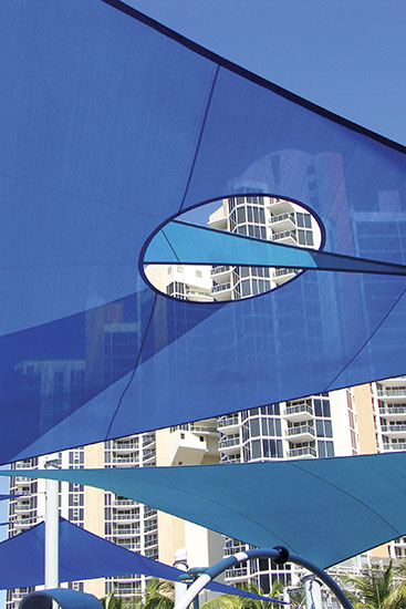 Blue Tension Sail shade structures over blue sky.